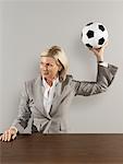 Businesswoman Throwing Soccer Ball