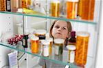 Boy Looking in Medicine Cabinet