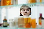 Girl Looking in Medicine Cabinet