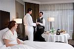 Hotel Guest Tipping Waiter For Room Service