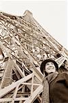 Woman by Eiffel Tower, Paris, France