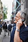 Homme dans la rue avec les téléphones cellulaires, Londres, Angleterre