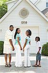 Family Standing In Front Of Garage