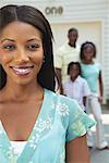 Woman with Her Family Standing In Front Of Garage