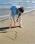 Homme dessin graphique sur le sable