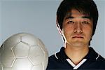 Determined soccer player holding ball