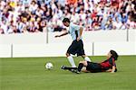 Soccer players battling for ball