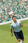 Soccer player juggling ball on head