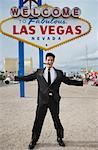 Man Standing by Sign, Las Vegas, Nevada, USA