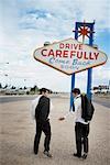 Men Walking by Sign, Las Vegas, Nevada, USA
