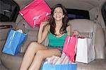 Woman in Limousine with Shopping Bags