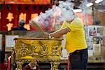 Man Making an Offering at a Temple, Chinatown, Singapore