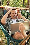 Man Lying on Hammock and Talking on Cellular Phone