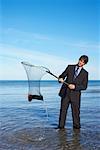 Businessman Fishing with Net