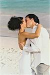 Bride and Groom Kissing on Beach