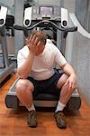Man Sitting on Treadmill