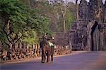 Man Riding Elephant At Gateway to Angkor Thom, Cambodia