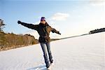 Woman Walking on Frozen Lake, Belgrade Lakes, Maine, USA
