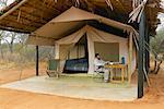 Man Reading At Campsite, Tanzania