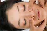Woman having face massaged
