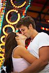 Couple Kissing at Amusement Park