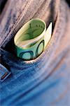 Close-up of a roll of Euro banknotes in a pocket