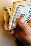 Businessman holding bankroll of United States currency, close-up