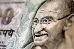 Image of man wearing glasses on bank note, extreme close-up