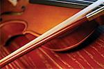 Close-up of violin and violin bow on wooden table