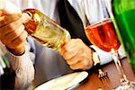 Close-up of a person's hand holding a glass of wine