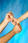 Close-up of a man and a woman's hands stacking fists