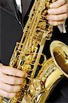 Mid section view of a musician playing the saxophone