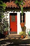 Red door on the facade of a Spanish style house, Los Angeles, California, USA