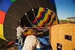 Rear view of two mid adult men near hot air balloon