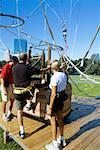 Close-up of men climbing into a hot air balloon basket, Boston, Massachusetts, USA