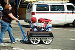 Mid adult woman pushing children in a trolley