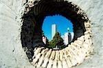 Skyscrapers viewed through a hole in a wall, Gateway Park, Chicago, Illinois, USA