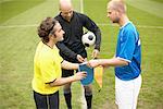 Footballers exchanging shields