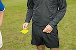 Referee giving yellow card