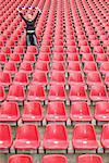 Female football fan alone in stadium
