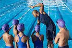 Coach and Students by Swimming Pool