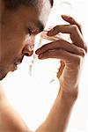 Man Cooling Off with Water Bottle