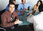 Business People with Snacks in Boardroom