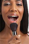 Woman Singing into Make-Up Brush