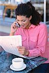 Woman with Cell Phone and Newspaper Outdoors