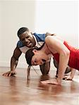 Woman Doing Push-ups with Trainer