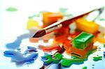 Close-up of watercolor paint cubes and a paintbrush