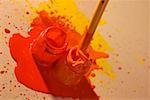 High angle view of a paintbrush dipped into a bottle of paint