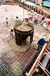 Workers on construction site pouring cement in new office building in Bethesda , Maryland