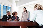 Three businesswomen and a businessman in an office